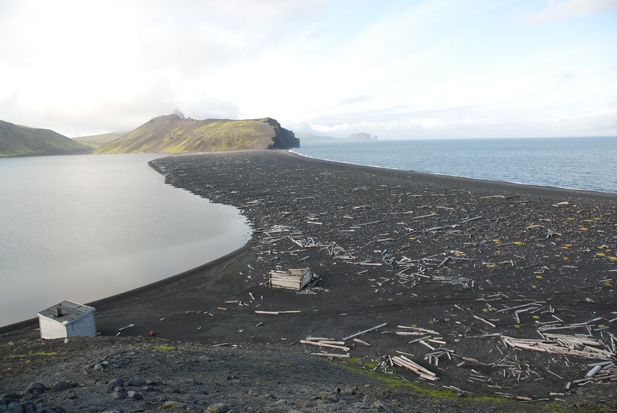 View toward North Lagoon (on left), the only lake on Jan Mayen that does not dry up in the summer. Through analysing seabed sediments here, researchers hope to see how the weather has changed and affected the island. To the right is the sea. Photo: Eiliv Larsen, NGU