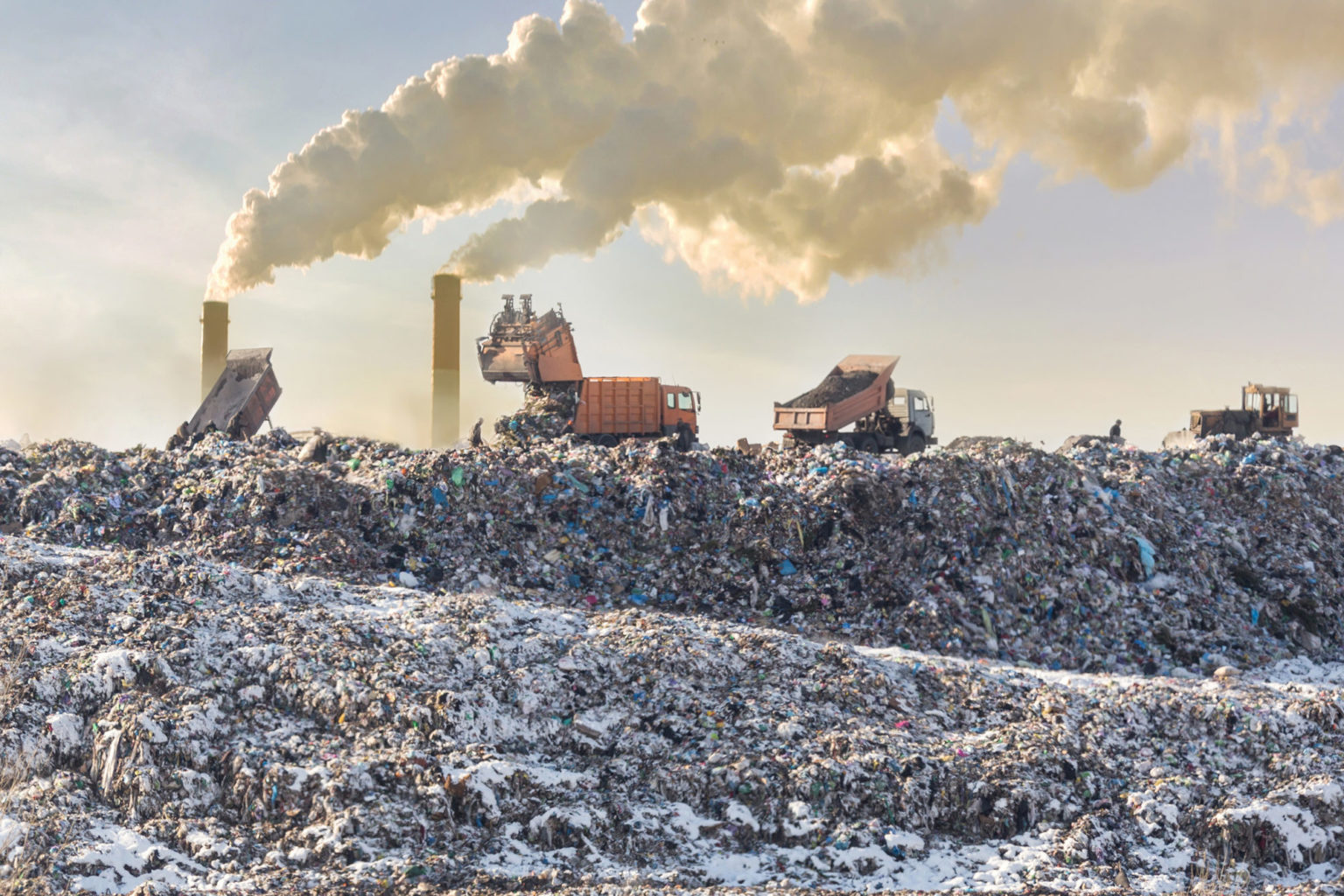 dump-trucks-unloading-garbage-over-vast-landfill-smoking-industrial