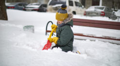 Barn leker i snøen i byen.