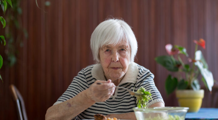 Vold mot eldre. Bildet viser en gammel dame som sitter ved et bord, og spiser mat.