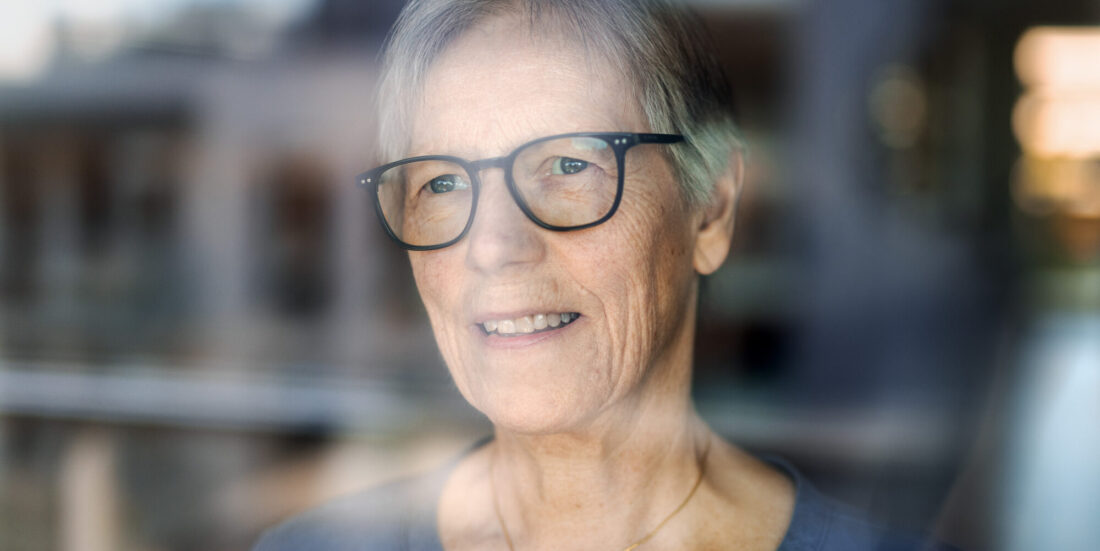 Bilder viser Ragnhild Langli som står bak et vindusrute.