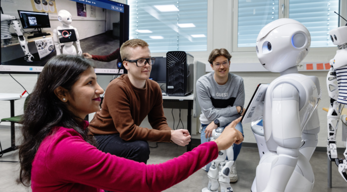 Bildet viser roboten Pepper sammen med studenter.