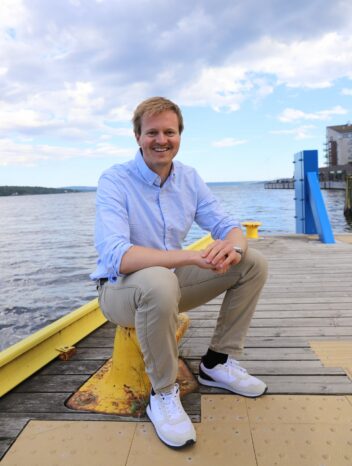 John Martin Kleven Godø sitter på en kai.